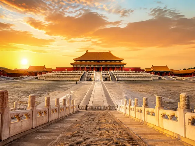 The Forbidden City in Beijing with red walls and golden roofs at sunrise